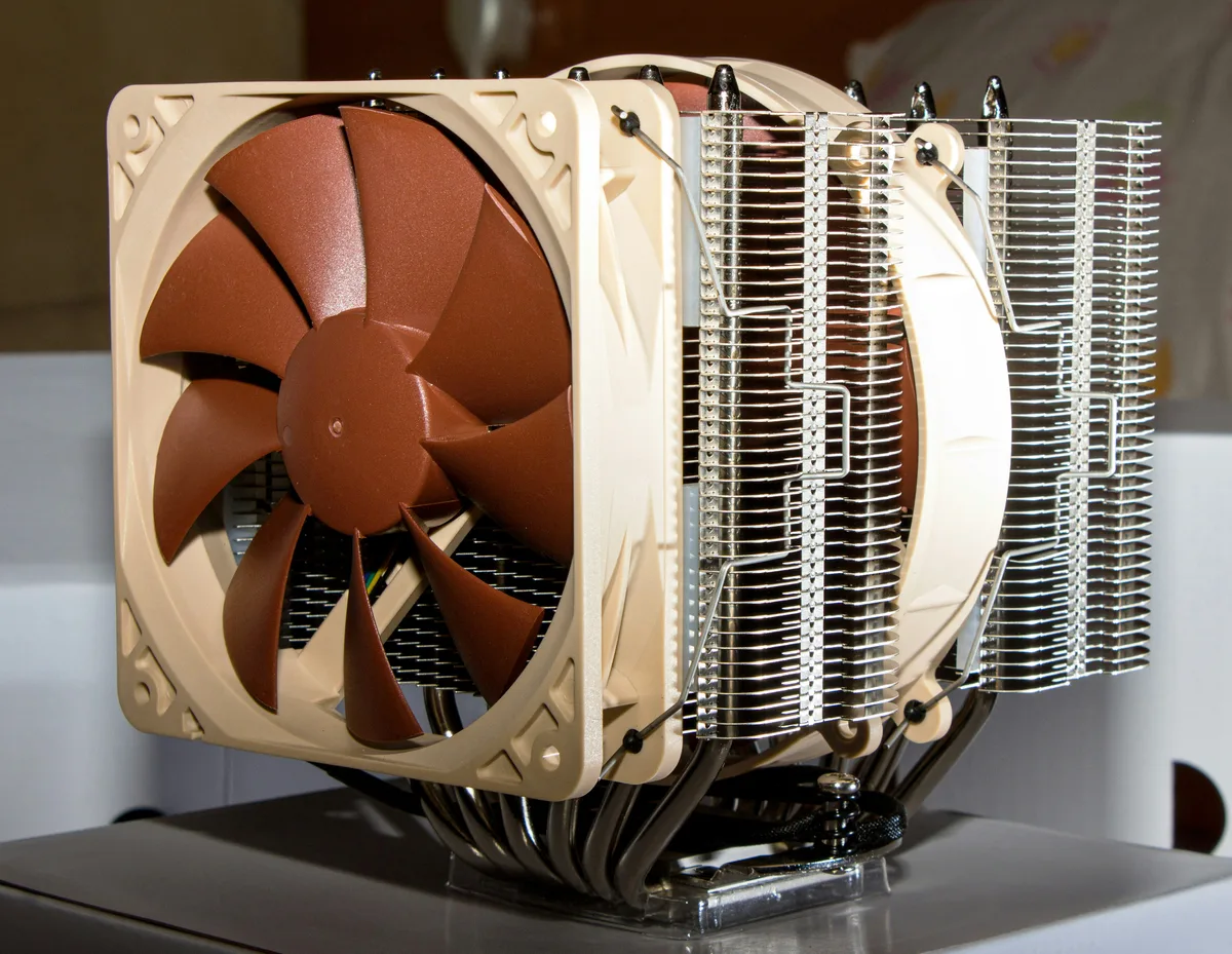 Close-up of a beige and brown high-performance case fan mounted to a finned CPU heatsink.