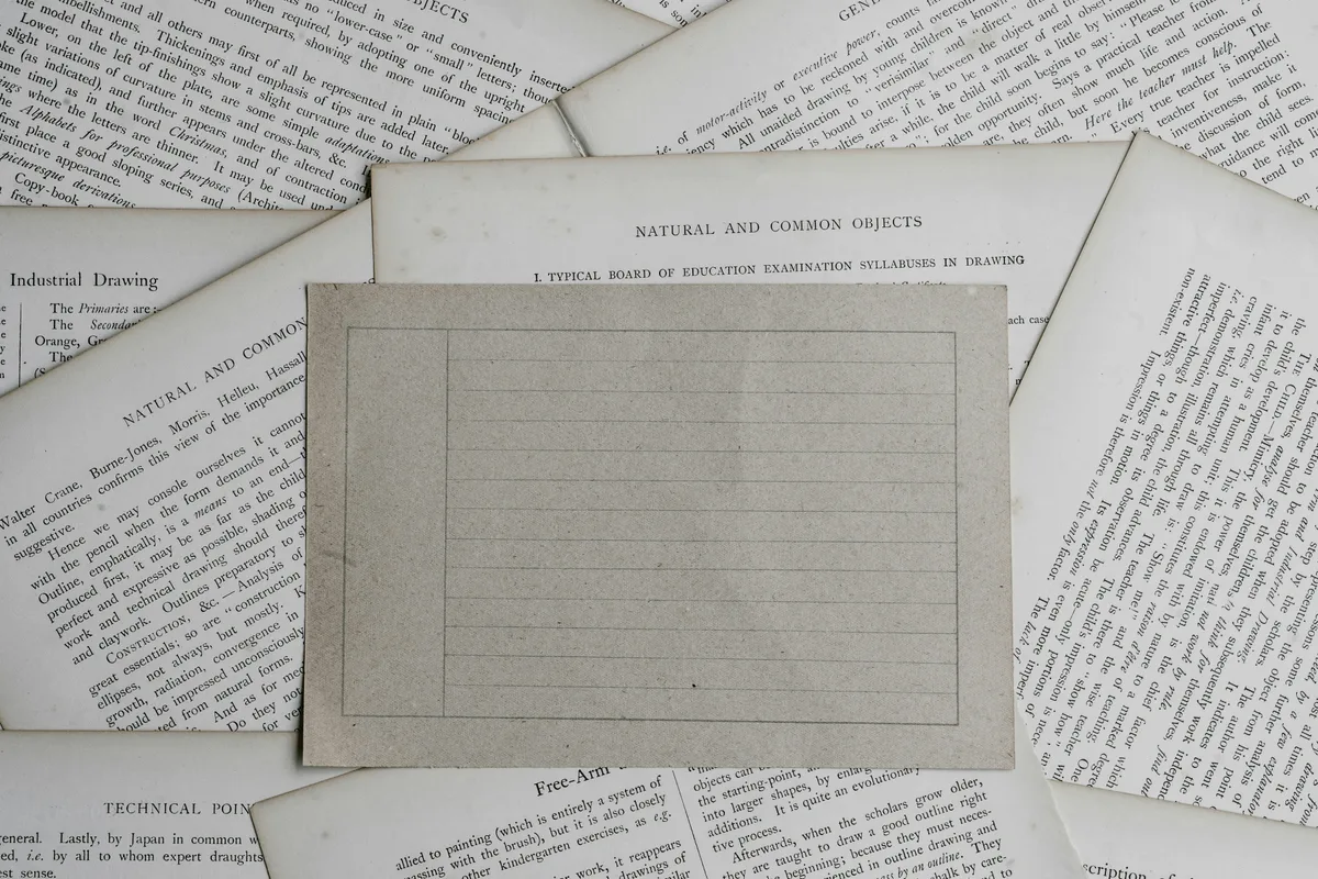 A sheet of plain ruled paper filling the frame, its faint horizontal lines empty and waiting to be written on.